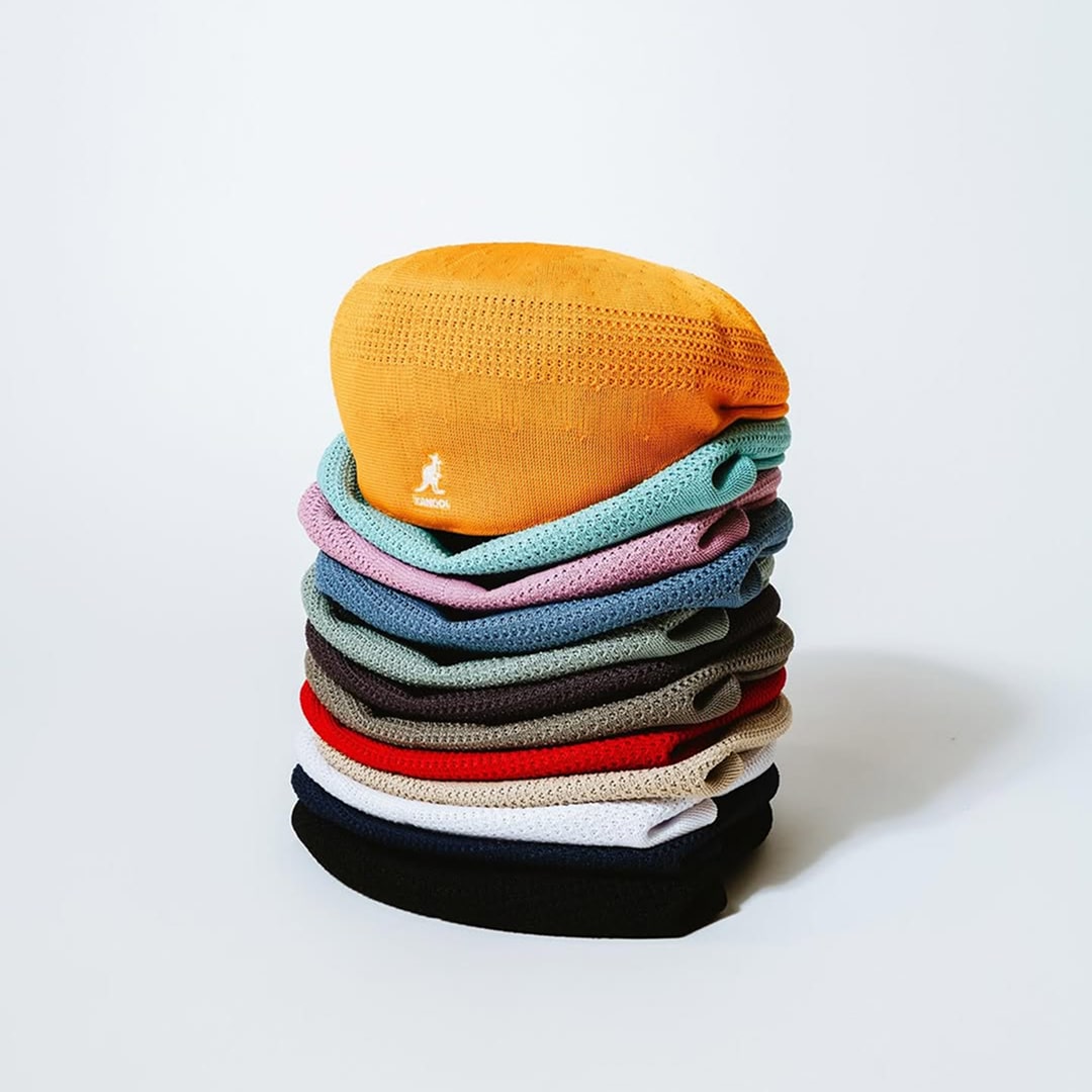 Stack of colorful beanies photographed on white background