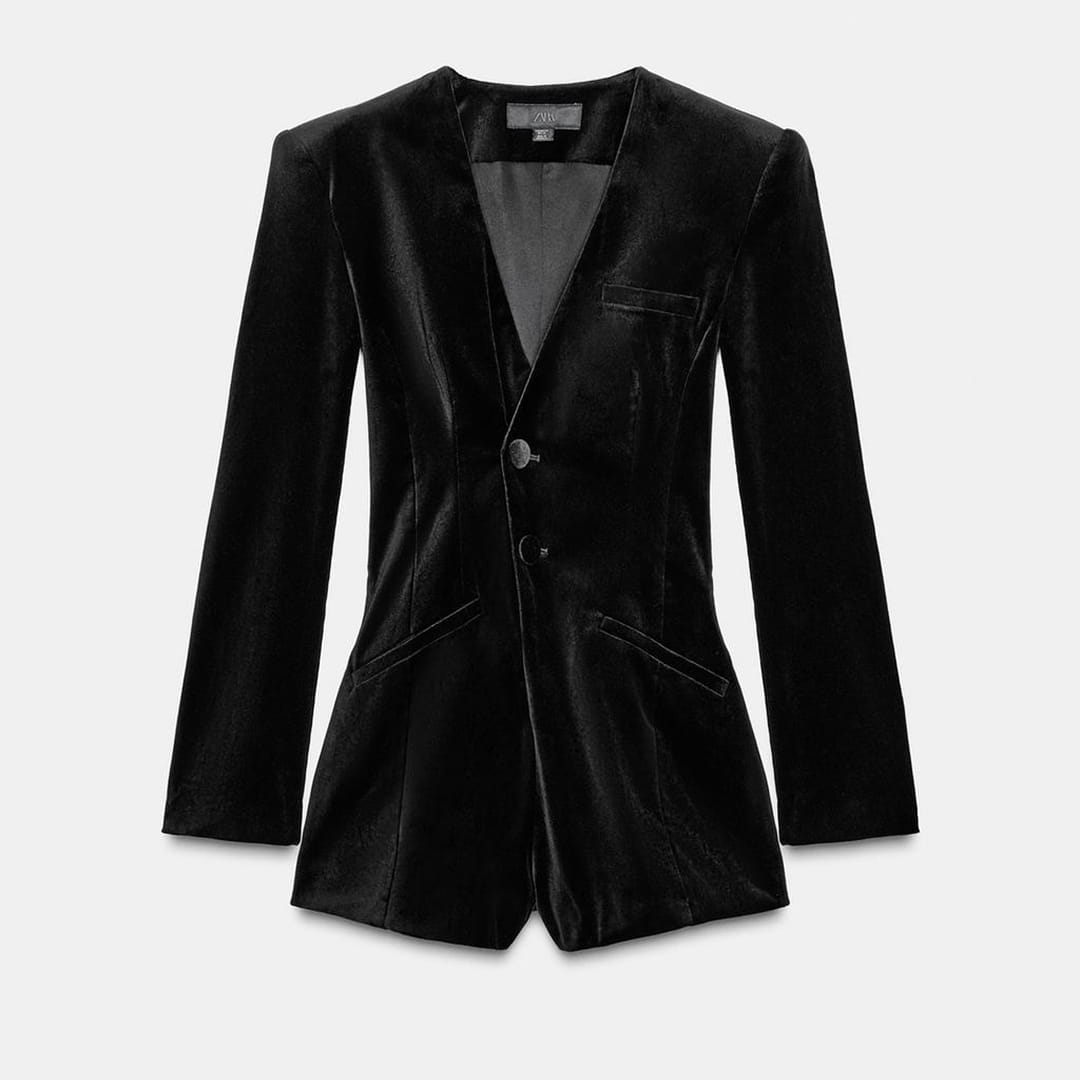 Black velvet blazer photographed on white background showing depth and light absorption
